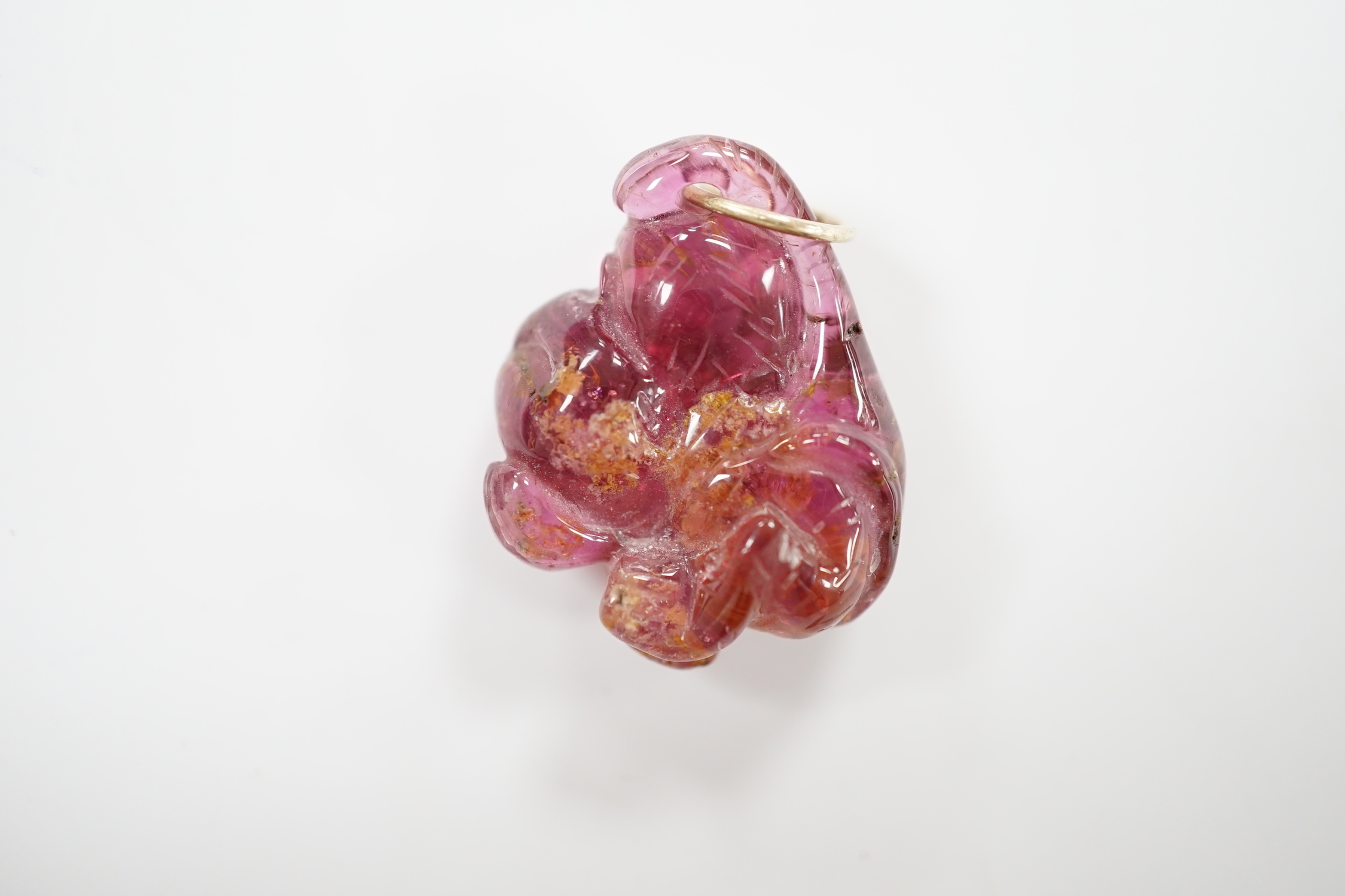 A novelty pink tourmaline and two stone diamond set pendant, modelled as a monkey, 25mm.